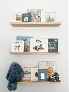 two wooden shelves with books and stuffed animals on them