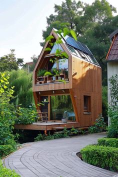 a small house with a roof that is made out of wood and surrounded by greenery