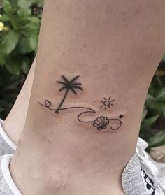 a small palm tree tattoo on the ankle