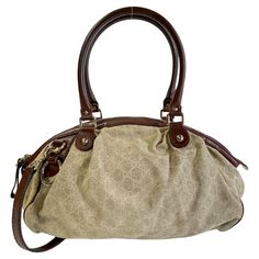 Color: Beige with brown leather Material: canvas with leather finishes Style No.: 223974 Measures: H 10” x L 18” x D 7” Drop: 8” (top handle)& 16” (shoulder strap) Comes with: shoulder strap Condition: Good. Discoloration marks to the bottom, marks and light stains throughout. Made in Italy Gucci Satchel Shoulder Bag With Handles, Gucci Satchel Shoulder Bag, Gucci Satchel With Handle Drop For Shopping, Everyday Handheld Gucci Satchel, Gucci Brown Coated Canvas Shoulder Bag, Brown Gucci Coated Canvas Shoulder Bag, Gucci Beige Satchel With Detachable Handle, Gucci Top Handle Shoulder Bag With Leather Trim, Gucci Shoulder Bag With Leather Trim