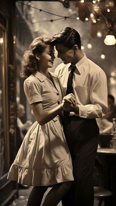 a man and woman are dancing together in an old fashion photo taken by the photographer