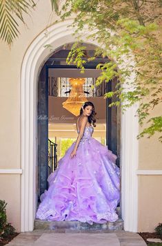 Details: Bursting with flowers, Lavender Dream gown embraces her floral name with stunning overlay of embroidered nature-inspired tulle, covered with 3D flowers in different shades of pink and purple, pearls, beads, and shimmery sequins. The sweetheart bodice is covered with hand sewn flowers and pearls. The real star is the ruffles on the train of the dress to create a dazzling dimension and movement to this gorgeous gown. The corset back provides a fully adjustable and customizable fit. Featur Lavender Debut Gown, Luxury Lavender Romantic Ball Gown, Lavender Ruffled Wedding Gown, Lavender Floor-length Ball Gown For Debutante Ball, Luxury Purple Tulle Quinceanera Dress, Bar In Home, Dresses With Corsets, Sewn Flowers, Gowns Couture