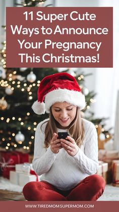 a woman sitting in front of a christmas tree looking at her phone with the text 11 super cute ways to announce your pregnant this christmas