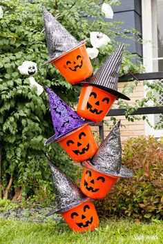 halloween decorations in the yard with pumpkins and witch hats on them, all made out of plastic cups