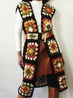 a woman wearing a crocheted vest and skirt