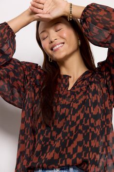 Refresh your fall wardrobe with this stylish printed blouse by EVEREVE. Finished in semi-sheer fabric, this flowy silhouette features long puff sleeves, ruffled seams, and a split neckline with a covered button. Take it from day to night with jeans or vegan leather pants. Note: This top is unlined. Cami not included. Fall Viscose Blouse With Ruffles, Fall Viscose Ruffle Top, Fall Ruffle Viscose Tops, Long Sleeve Viscose Blouse With Ruffles, Fall Flowy Blouse With Bishop Sleeves, Flowy Lantern Sleeve Blouse With Ruffles, Flowy Ruffle Hem Blouse For Fall, Flowy Blouse With Gathered Sleeves For Fall, Flowy Balloon Sleeve Blouse With Ruffles