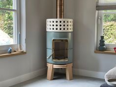 a blue stove sitting next to a window in a living room