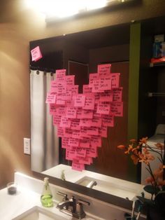 two pictures of a bathroom with pink sticky notes on the wall and in the mirror