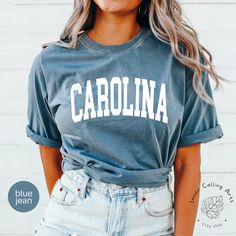 Minimalist Carolina Shirt, Comfort Colors®, Vintage Carolina Tee, Carolina Fan Sweatshirt Carolina Tshirt Carolina Gift College Student gift Hi, thank you so much for shopping with us! ❤️ ◦ ◦ ◦ ◦ ◦ size and material ◦ ◦ ◦ ◦ ◦ ◦ Comfort Colors® Original Garment-Dyed T-shirt ◦ Unisex Adult T-Shirt ◦ Soft and comfy ◦ Garment-dyed and soft-washed for a comfortable vintage look and feel ◦ Relaxed fit ◦ 100% ring-spun cotton ◦ The way that we print our sweatshirts is Direct-to-Garment printing, meaning that the ink is printed INTO the shirt. This provides an extremely durable and professional look (not vinyl).  ❤️❤️ IF YOU WANT AN OVERSIZED LOOK PLEASE CHOOSE A SHIRT THAT IS 2 SIZES LARGER THAN YOUR USUAL SIZE  ◦ ◦ ◦ ◦ ◦ care instructions ◦ ◦ ◦ ◦ ◦ ◦ Machine wash: cold (max 30C or 90F) ◦ Do not Casual Name Print T-shirt For Fall, Casual Fall T-shirt With Name Print, Casual Gray T-shirt For College, Gray College-style Top With Letter Print, Casual Name Print T-shirt, Casual Gray Shirt With Letter Print, Casual Everyday Tops With Name Print, College Style Cotton T-shirt For Fall, Trendy Gray Tops For College