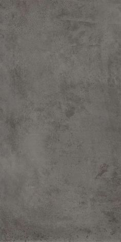 an image of a concrete wall textured with dark gray paint or stain on it