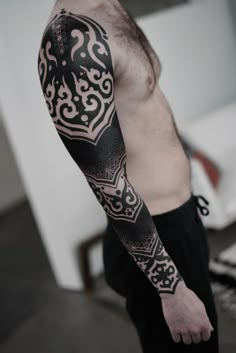 a man with a black and white tattoo on his arm