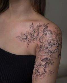 a woman's shoulder with flowers on it