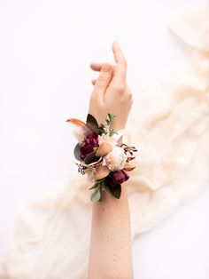 a woman's arm wearing a flower wrist corsage