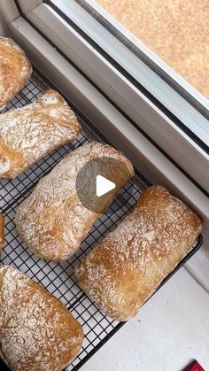 several pastries cooling on a rack in front of a window