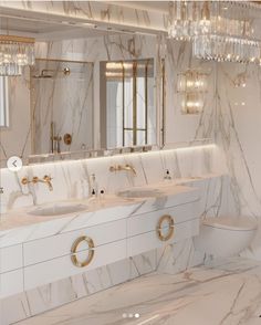 a bathroom with marble counter tops and gold accents