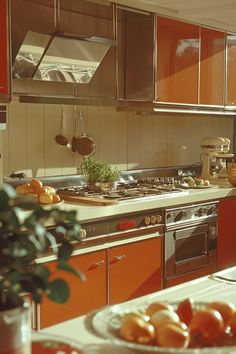 a kitchen with orange cabinets and stainless steel appliances