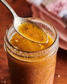 a spoon full of peanut butter on top of a wooden table