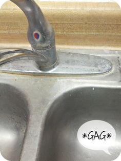 a metal sink with two faucets in it