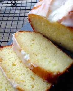 a loaf of lemon pound cake sitting on top of a cooling rack with frosting