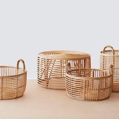 four baskets sitting on top of a wooden table