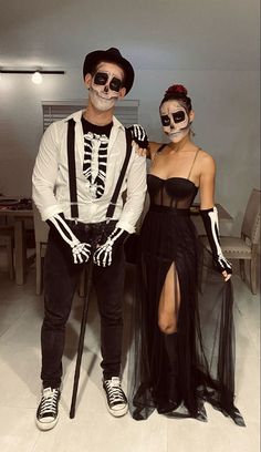 a man and woman dressed up in skeleton costumes