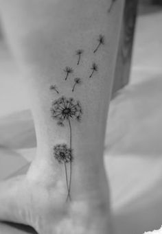 a dandelion tattoo on the ankle is shown in black and white, with small details