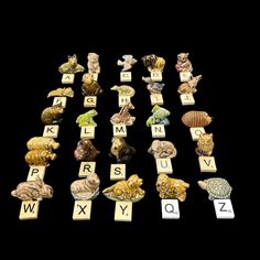 many different types of animals and letters are arranged in the shape of scrabbles