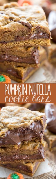 pumpkin nutella cookie bars stacked on top of each other with chocolate frosting and candy