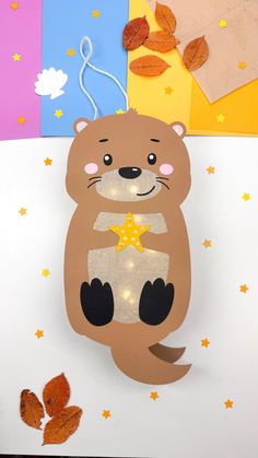 a paper cut out of an animal with stars on its chest and paws in the air