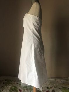 "How simple and beautiful is that! The totally white makes it divinely simple! Cotton strapless dress with some stretch fitted bust, fully lined with white satiny lining that ends to a tulle petticoat all around the finishing hem by creating a semi-full skirt from the mid '90s. Closes with a painted metal zipper up back. A bit fitted waistline, flared circle skirt that is enriched with a white tulle petticoat (You may also add one more petticoat if you have one and you want to give even more vol White Fitted A-line Strapless Dress, White Fitted Strapless A-line Dress, White Knee-length Strapless Wedding Dress, White Strapless Knee-length Summer Dress, White Knee-length Strapless Summer Dress, White Sleeveless Petticoat For Spring, White Sleeveless Petticoat For Summer, Fitted White Petticoat For Summer, Fitted Knee-length Summer Petticoat