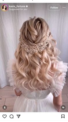 the back of a woman's head with long blonde hair and a tiara