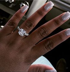 a woman's hand with a diamond ring on it