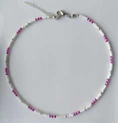 This dainty necklace is handmade with white/pink/purple and silver seed beads. - The necklace is about 14 inches long, however each necklace purchased comes with a chain extender ( 2 inches) so that you may adjust it to your desired length. -  The fittings are plated with silver, if exposed to water/ perfumes or lotion, time it will tarnish or wear off. - This necklace is perfect for layering with personal items or more Olivia St. Croix necklaces. ;) UK Delivery Free shipping with Royal Mail 2nd Seed Bead Necklace Choker, Seed Bead Jewelery, White Seed Bead Necklace, Purple Bead Necklace, Beaded Jewelry Necklaces, Beading Jewelery, Purple And Silver, Bead Necklaces, St Croix