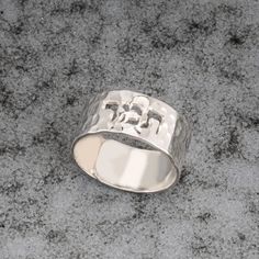 925 Silver Hammered Cutout Hebrew Name Ring - the band of the ring is carefully crafted to ensure a comfortable fit, with smooth edges and a polished interior surface. The width of the band is designed to strike the perfect balance between elegance and visibility, allowing the cutout Hebrew name to stand out while maintaining overall wearability. * Material: High Quality 925 Sterling Silver  * Handmade item * 0.7mm Thickness SIZES * Ring length: 7.5mm * Ring size: The ring is open and the size c Silver Hallmarked Initial Ring For Wedding, Sterling Silver Open Ring For Anniversary, Sterling Silver Promise Ring With Thick Band, Sterling Silver Promise Ring With Wide Band, Silver Hammered Open Band Rings, Silver Sterling Silver Wide Band Promise Ring, Silver Promise Ring With Wide Band, Silver Wide Band Stackable Rings For Wedding, Silver Wide Band Stackable Wedding Rings