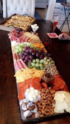 a long table filled with different types of food and snacks on top of each other