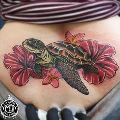 a woman's stomach with a turtle and flowers on it