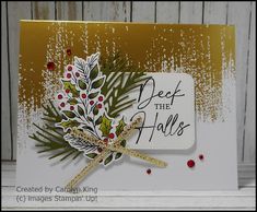 a close up of a christmas card with holly and mist on the side, which reads deep in the holly