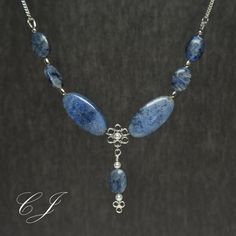 "Dumortierite is a rare blue gemstone that usually forms as inclusions in quartz. This adjustable necklace is handmade using Flower and Sunset Dumortierite beads. This classic necklace is completely handmade by Cohee Jewelry in USA.  The elegant style would be a great jewelry accessory or evening or formal wear. Matching earrings are available for both pierced and non-pierced ears.  Clasp: Handmade Sterling Silver Hook Extender: Handmade 2\" Sterling Silver Swarovski Crystal Pearl accent beads. Blue Labradorite Jewelry With Natural Stones, Blue Labradorite Gemstone Bead Necklaces, Blue Labradorite Gemstone Beads Necklace, Blue Labradorite Necklaces For Healing, Elegant Apatite Necklace As Gift, Elegant Apatite Necklace For Gifts, Labradorite Beaded Jewelry As A Gift, Blue Labradorite Gemstone Necklace, Blue Gemstone Necklace In Labradorite