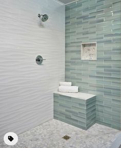 a bathroom with a glass tile shower wall