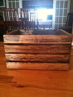 a wooden box sitting on top of a hard wood floor