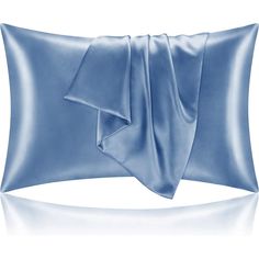 a blue satin pillow on a white background