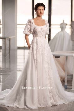 a woman in a white wedding dress posing for the camera