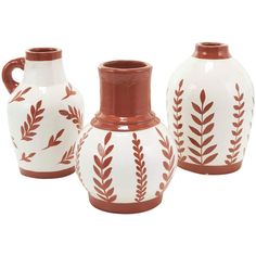 three white and red vases sitting next to each other