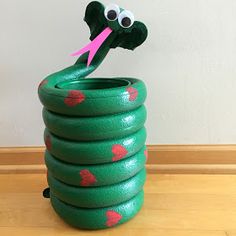 a stack of green rubber tires sitting on top of a wooden floor