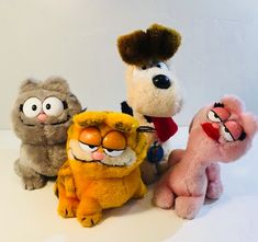 five stuffed animals are lined up on a table