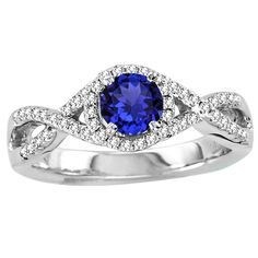 a white gold ring with an oval blue sapphire surrounded by diamonds