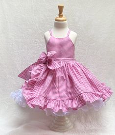 "Pink Gingham babygirl tulle dress Welcome to my shop.  Get ready to make a statement with this adorable Pink Gingham babygirl dress. This fun, pretty pink gingham ruffle dress is the perfect dress for your little one's birthday party, Halloween costume, pageant dress, or any special occasion.  This lovely dress is handmade from start to finish, by me in my studio.  There is no doubt your little one will be so excited to wear this pink gingham barbie costume.  *The bodice and skirt are fully lin Gingham Barbie, Baby Tulle Dress, Pageant Costumes, First Birthday Dresses, Barbie Costume, Wonder Woman Costume, Pageant Dress, Pink Gingham, Pinafore Dress