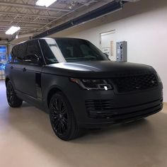 a black range rover parked in a garage