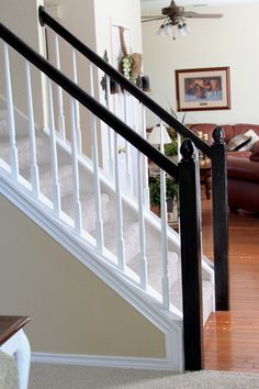 a living room filled with furniture and a stair case