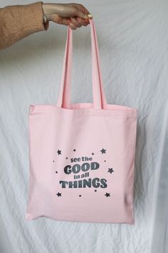 "This adorable tote bag features the quote \"see the good in all things.\" It's the perfect go-to reusable tote! PRODUCT DETAILS: -dimensions - 14\" x 16\" -colors available - natural and light pink -100% heavy cotton canvas -all designs are created by oriJENal Creations Questions?? Want a custom piece?? Please don't hesitate to contact me!" Bachelorette Party Favor Bags, Totes Ideas, Minimalist Tote Bag, Sacs Tote Bags, See The Good, Bag Quotes, Best Tote Bags, Painted Tote, Canvas Cosmetic Bag